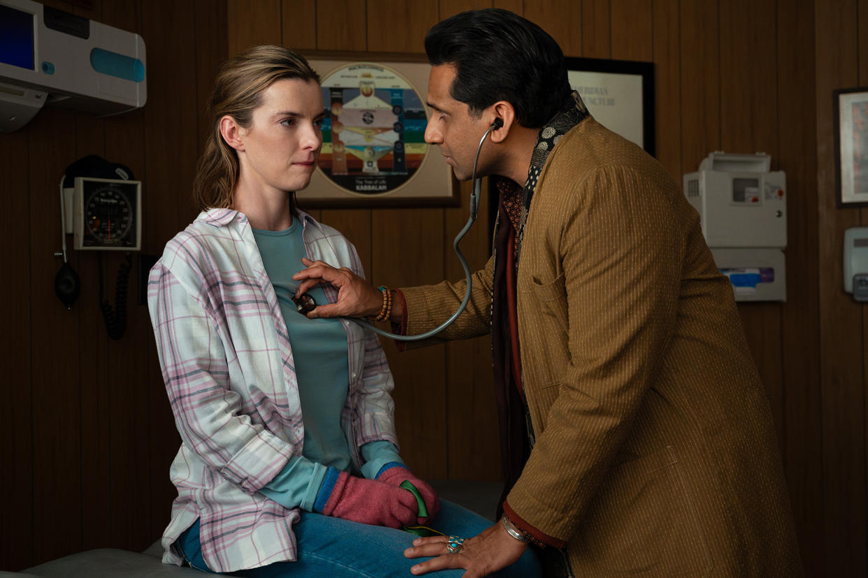 The actor Betty Gilpin in a movie scene set in a doctor's office.