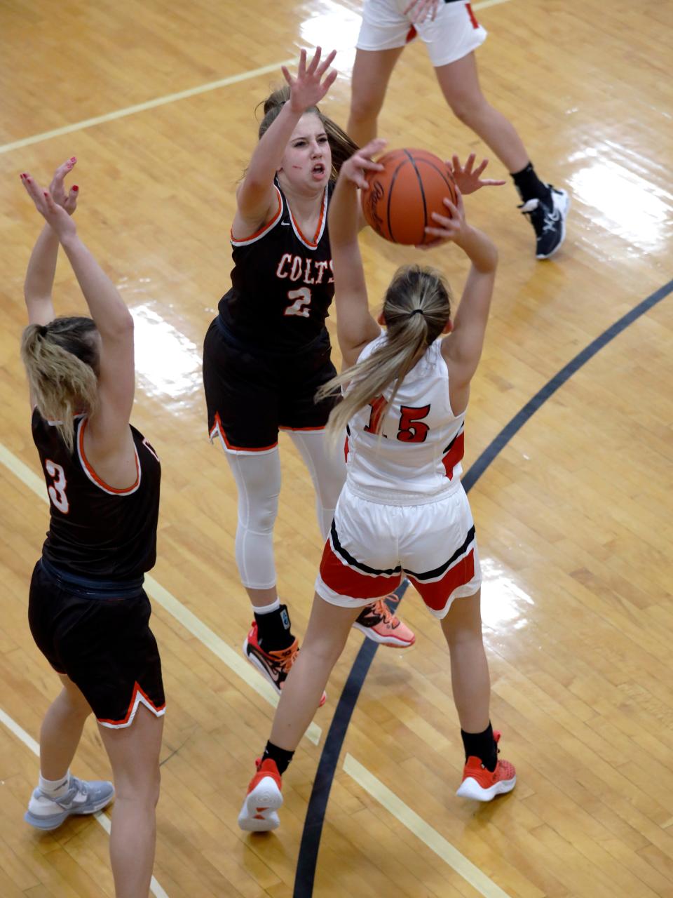 Karly Launder, left, and Kenli Norman trap Isabelle Lauvray during Meadowbrook's 61-33 win against host Coshocton on Wednesday night at The Wigwam. The Colts led by as many as 34 points in the second half.
