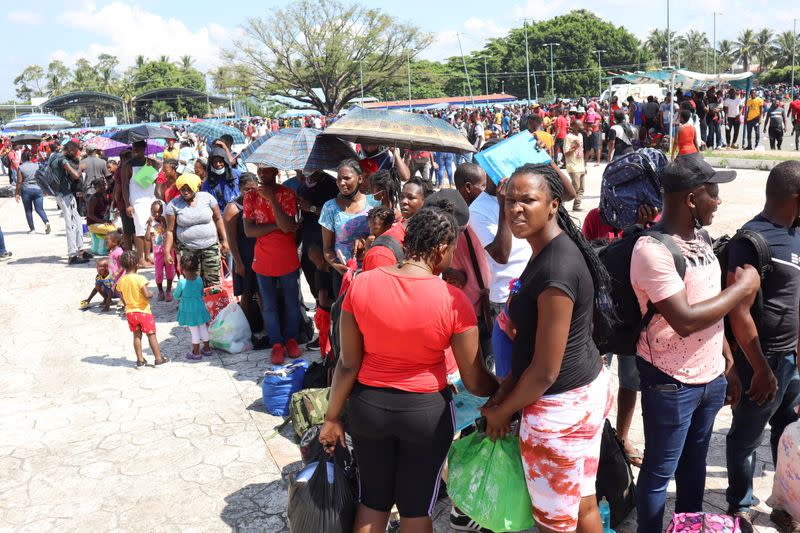 Migrants, mostly Haitians, queue outside a stadium to apply for humanitarian visas, in Tapachula