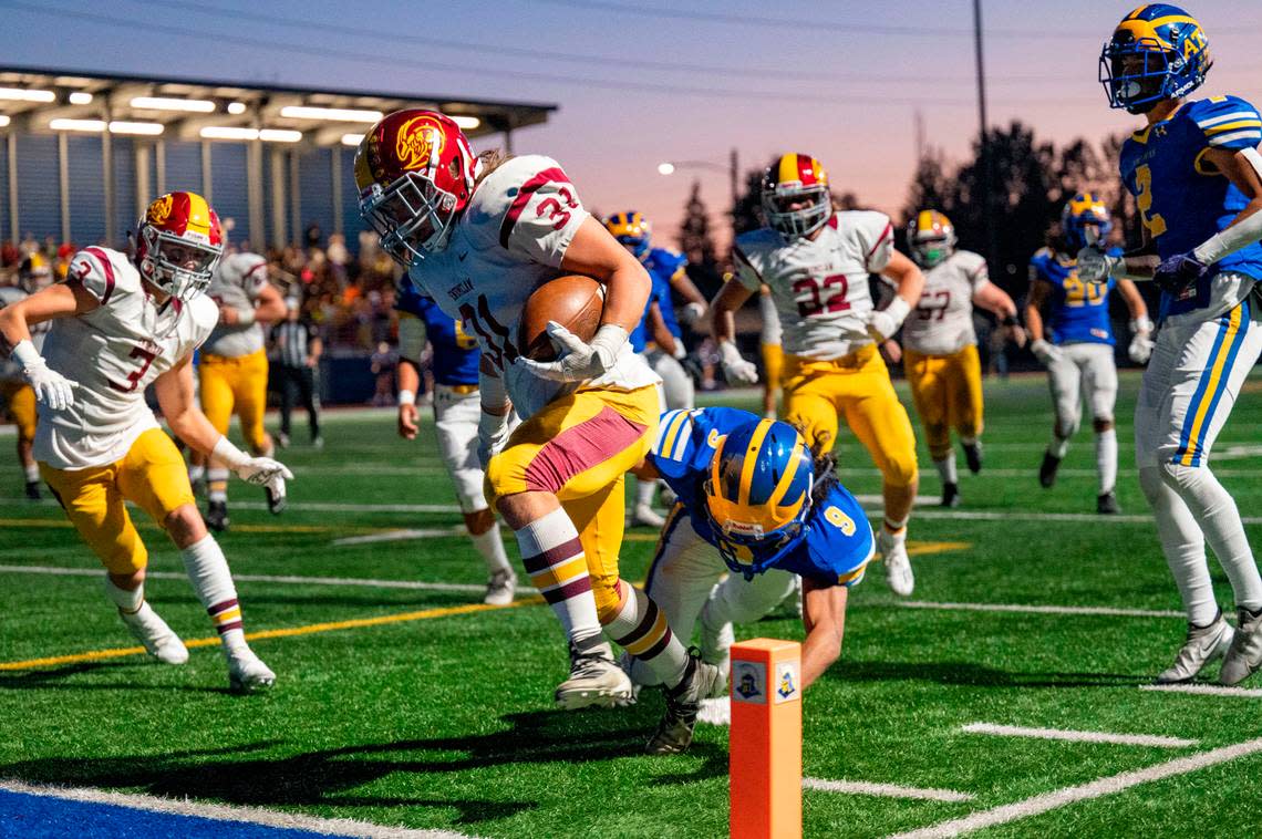 Enumclaw running back Emmit Otero breaks through a tackle attempt by Fife’s Drew Francis as he scores a touchdown in the second quarter of 2A SPSL game on Thursday, Sept. 22, 2022, at Fife High School in Fife, Wash.