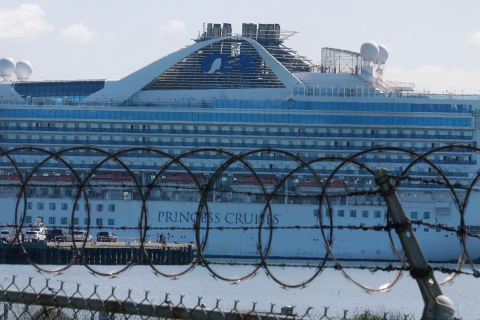 Wire fencing is shown in front of the Grand Princess cruise ship, which carried multiple people who have tested positive for COVID-19, docked at the Port of Oakland in Oakland, Calif., March 11, 2020. 