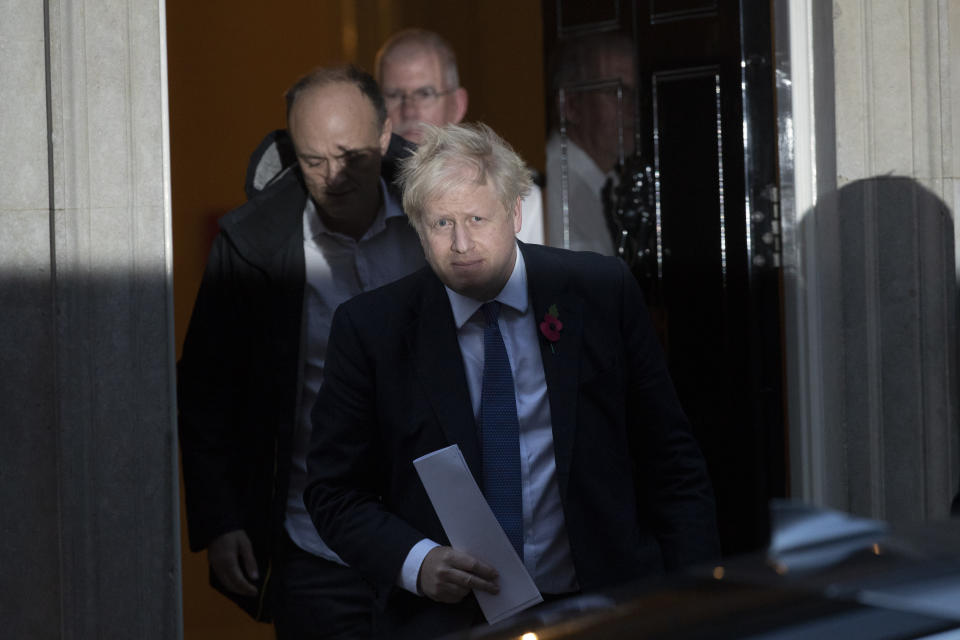 British Prime Minister Boris Johnson and his advisor Dominic Cummings, left, leave 10 Downing Street in London, and get in a car together to go to the Houses of Parliament, Monday, Oct. 28, 2019. British Prime Minister Boris Johnson says it's Parliament's fault, not his, that Britain will not be leaving the European Union as scheduled on Oct. 31. The EU has agreed to postpone Brexit until Jan. 31, 2020, after Johnson failed to get British lawmakers to ratify his divorce deal with the bloc in time to leave this week. (AP Photo/Matt Dunham)