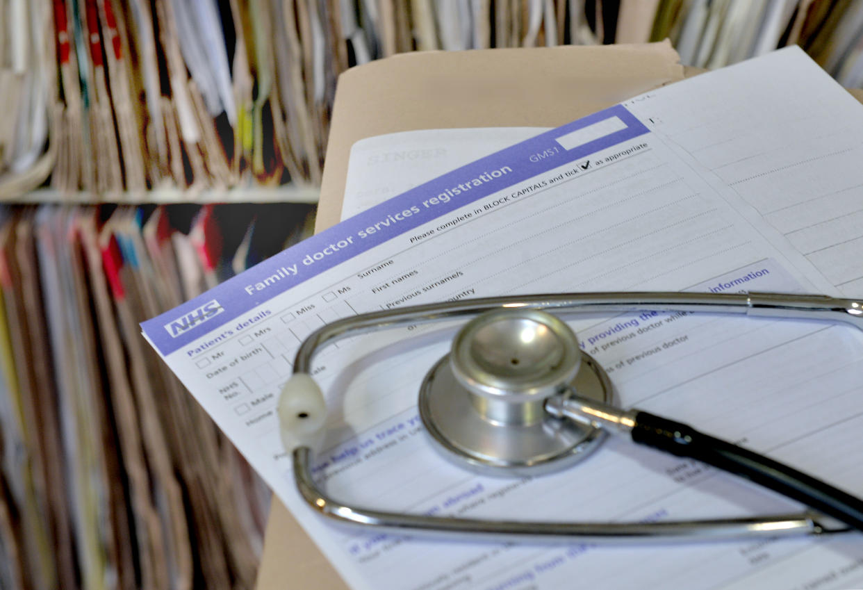 A registration form and a stethoscope at the Temple Fortune Health Centre GP Practice near Golders Green, London.