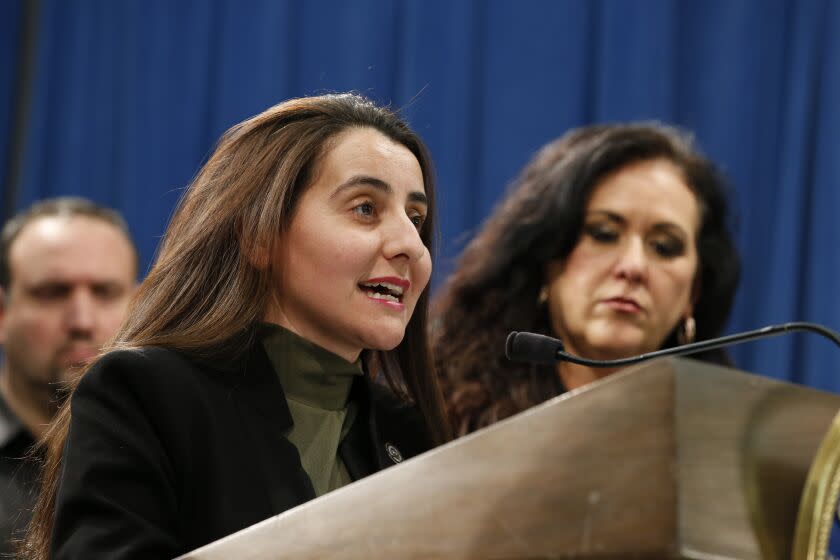 Assemblywoman Monique Limon, D-Santa Barbara, discusses the proposed measure she and Assemblywoman Lorena Gonzalez, D-San Diego, right, authored that would require insurance companies to cover all existing homes, during a news conference, in Sacramento, Calif., Tuesday, Feb. 18, 2020. The bill comes years after deadly fires led to insurers turning down more customers. It would also require insurance companies to give financial incentives for fire-safety upgrades. (AP Photo/Rich Pedroncelli)