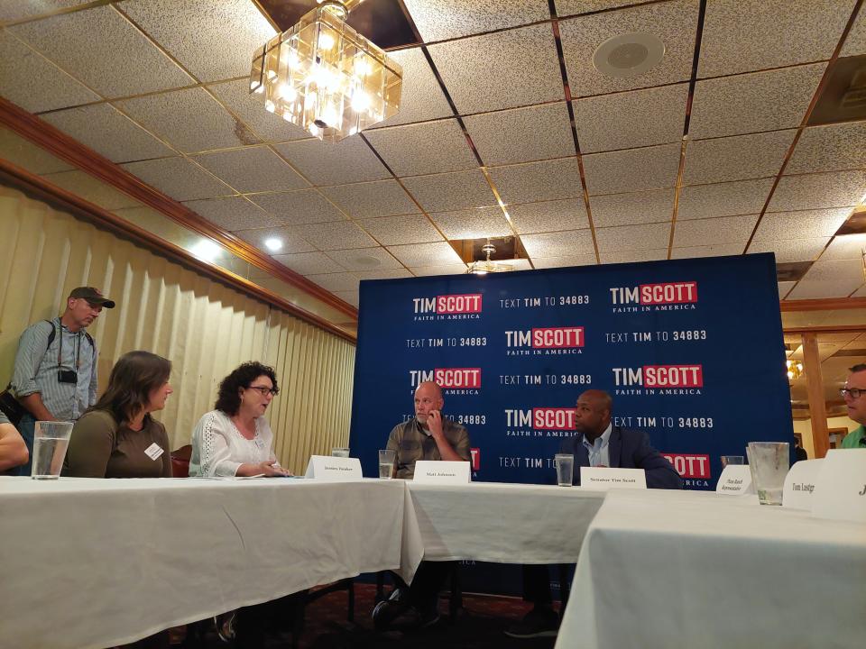 US. Sen. Tim Scott of South Carolina, who is seeking the Republican nomination for president, talks with Iowans at an event in Council Bluffs June 2, 2023.