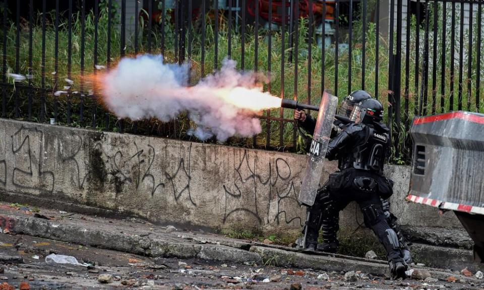 Riot police officers fire teargas at demonstrators in Cali on 10 May.