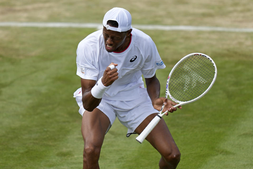 Christopher Eubanks of the US celebrates winning a point against Stefanos Tsitsipas of Greece in a men's singles match on day eight of the Wimbledon tennis championships in London, Monday, July 10, 2023. (AP Photo/Alastair Grant)