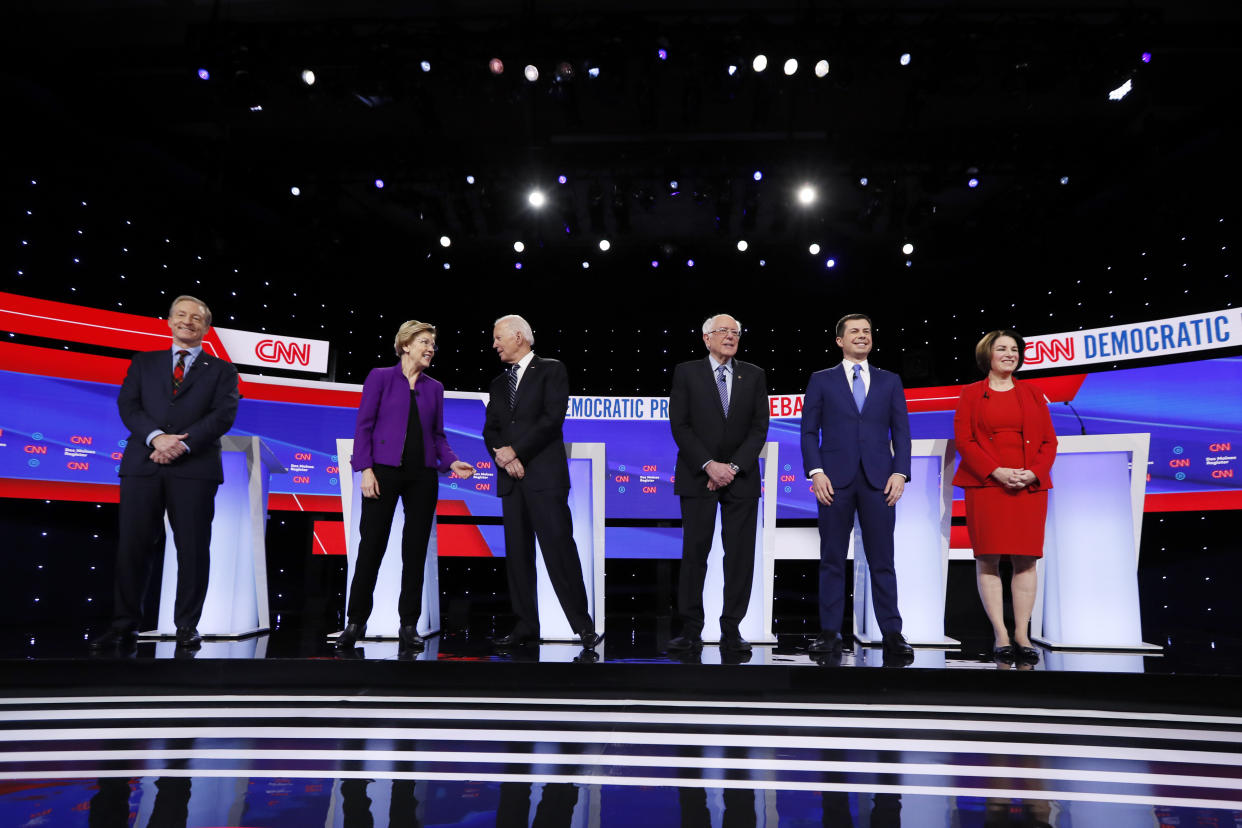 Democratic presidential candidates stand before a primary debate in Des Moines last month. (AP Photo/Charlie Neibergall)  