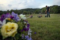 Eddie Davis steps up to the gravestone of his son Jeremy, who died from the abuse of opioids, Wednesday, July 17, 2019, in Coalton, Ohio. Newly released prescription opioid statistics underscore how widespread pill use has been in towns and small cities of America’s Appalachian region. In Jackson County, an average yearly total of 107 opioid pills for every resident were distributed over a seven-year period. (AP Photo/John Minchillo)