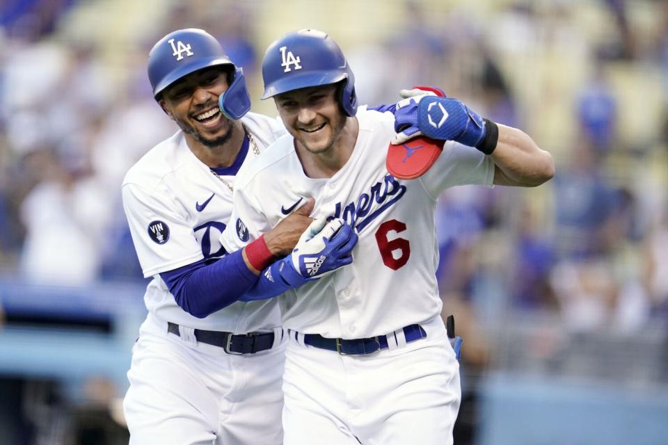 The Dodgers' Trea Turner, right, celebrates after his two-run home run with Mookie Betts.