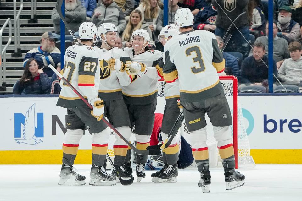Nov 28, 2022; Columbus, Ohio, USA;  Teammates celebrate a goal by Vegas Golden Knights center William Karlsson (71) during the first period of the NHL hockey game against the Columbus Blue Jackets at Nationwide Arena. Mandatory Credit: Adam Cairns-The Columbus Dispatch