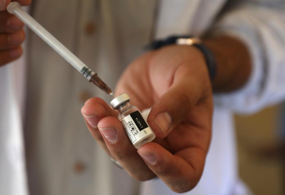 A doctor fills a syringe with the Johnson & Johnson COVID-19 vaccine at a vaccination center in Kabul, Afghanistan, Sunday, July 11, 2021. The COVID-19 vaccines were donated by the United States and delivered through the U.N.-backed COVAX program. Another shipment is expected to arrive later this month. (AP Photo/Rahmat Gul)