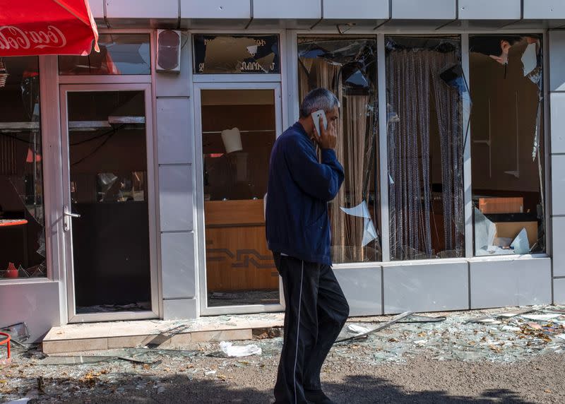 A man walks past a building that was allegedly damaged by recent shelling during a military conflict over the breakaway region of Nagorno-Karabakh