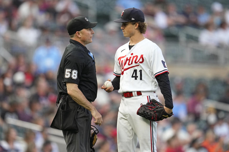 Minnesota Twins starting pitcher Joe Ryan (41) talks with home plate umpire Dan Iassogna, left, after giving up a solo home run to Detroit Tigers' Matt Vierling during the fourth inning of a baseball game Friday, June 16, 2023, in Minneapolis. (AP Photo/Abbie Parr)