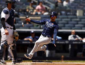 Tampa Bay Rays' Kevin Kiermaier scores a run past New York Yankees catcher Kyle Higashioka during the third inning of a baseball game on Monday, May 31, 2021, in New York. The Rays won 3-1. (AP Photo/Adam Hunger)
