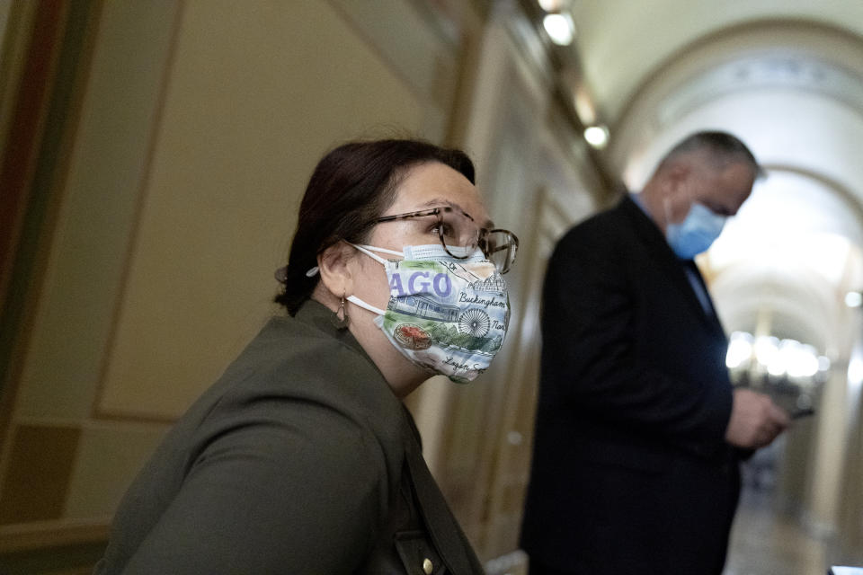 Sen. Tammy Duckworth, D-Ill., left, speaks with the media in the Capitol on the fifth day of the second impeachment trial of former President Donald Trump, Saturday, Feb. 13, 2021, in Washington. (Stefani Reynolds/Pool via AP)