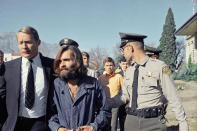 <p>Charles Manson, leader of a hippie cult linked to the Sharon Tate murders, is taken from jail to a courtroom at Independence, Calif., on Dec. 3, 1969, for a preliminary hearing on charges of possessing stolen property. At left is his public defender, Fred Schaefer. (Photo: AP) </p>