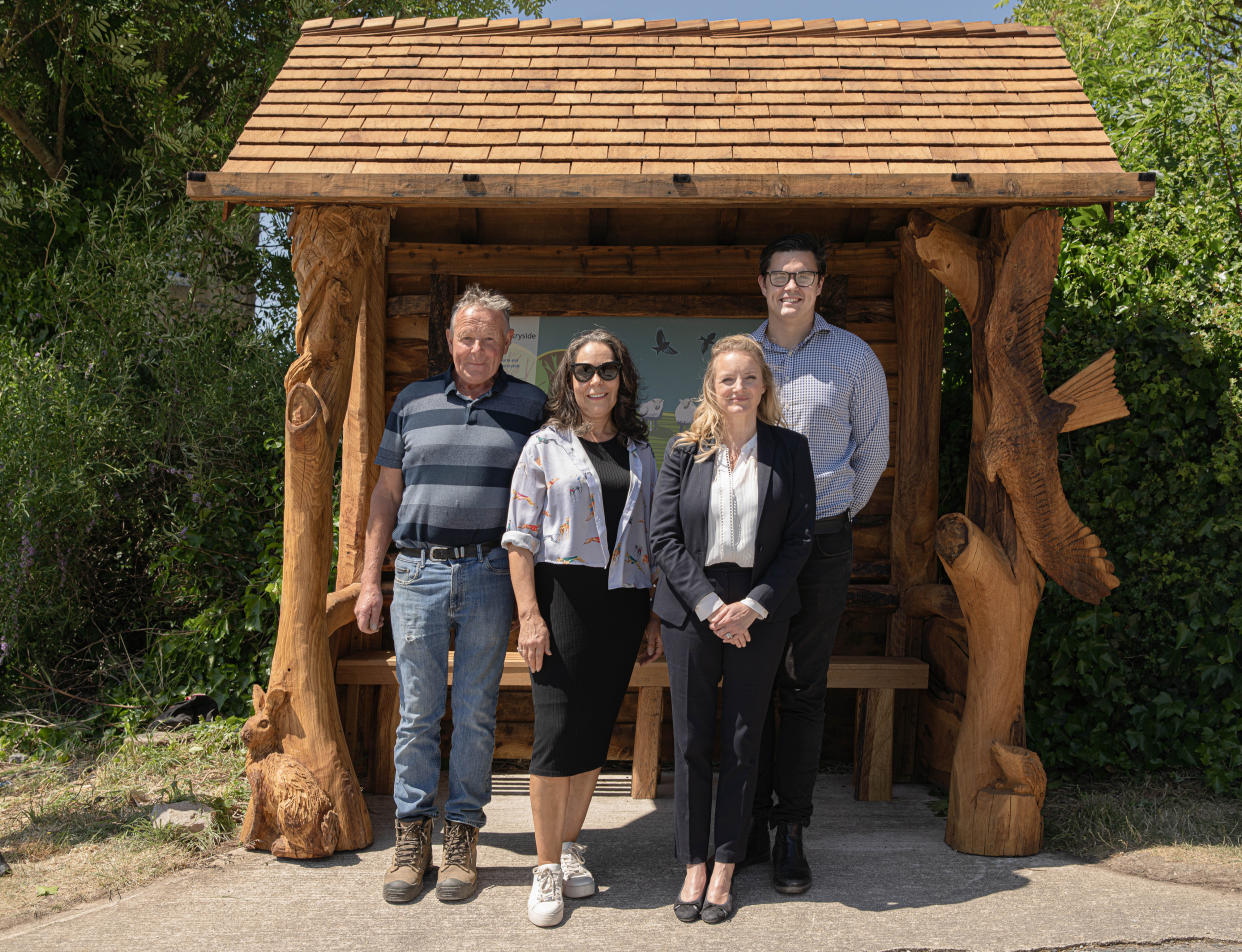  Nicola Wheeler and creative team stand in front of the new Emmerdale bus stop. 