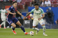 Austin FC defender Julio Cascante (18) moves the ball against FC Dallas forward Petar Musa, left, during the first half of an MLS soccer match Saturday, May 11, 2024, in Frisco, Texas. (AP Photo/LM Otero)