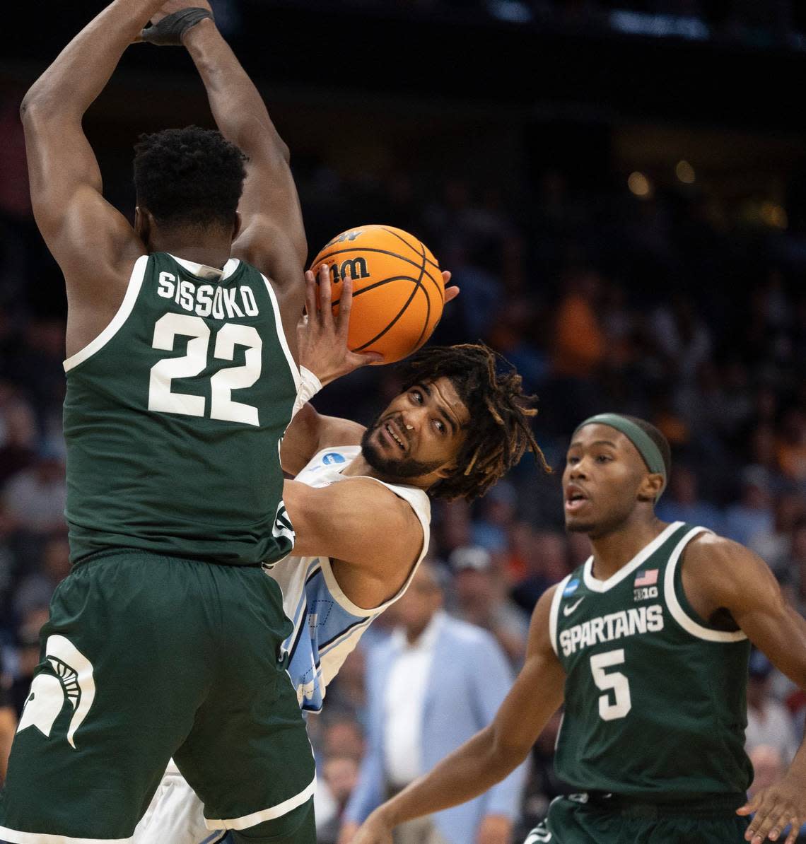Michigan State’s Mady Sissoko (22) and Tre Holloman (5) trap North Carolina’s R.J. Davis (4) during the second half on Saturday, March 23, 2024, during the second round of the NCAA Tournament at Spectrum Center in Charlotte, N.C.