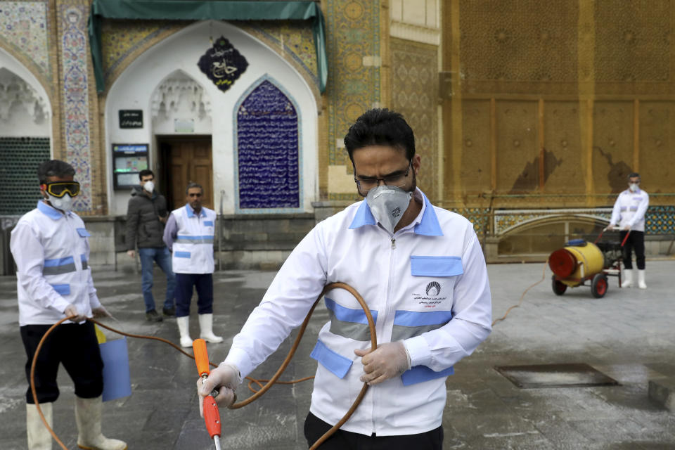 Workers disinfect the shrine of the Shiite Saint Imam Abdulazim to help prevent the spread of the new coronavirus in Shahr-e-Ray, south of Tehran, Iran, Saturday, March, 7, 2020. (AP Photo/Ebrahim Noroozi)