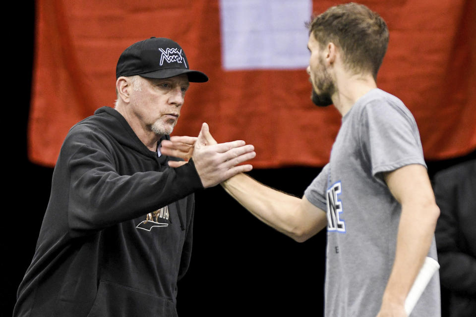 Former tennis pro Boris Becker stands in the hall during a training session before the first match and greets German player Oscar Otte at the Davis Cup, qualifying round tennis match between Germany and Switzerland in Trier, Germany, Friday, Feb. 3, 2023. (Harald Tittel/dpa via AP)