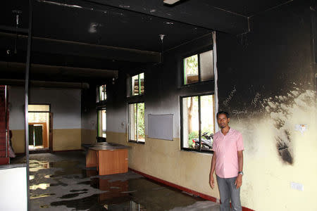 M.I. M Shukry, the secretary of Noor Jummah Mosque, poses where the first floor was firebombed during the clash in Digana, Sri Lanka March 17, 2018. REUTERS/Tom Allard