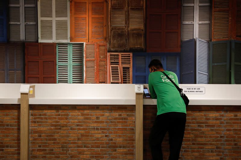 A food delivery rider takes a break at a shopping mall, amid the coronavirus disease (COVID-19) outbreak in Singapore