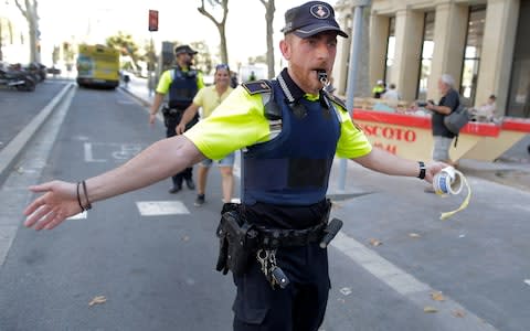 A police officer cordon off a street in Barcelona, Spain