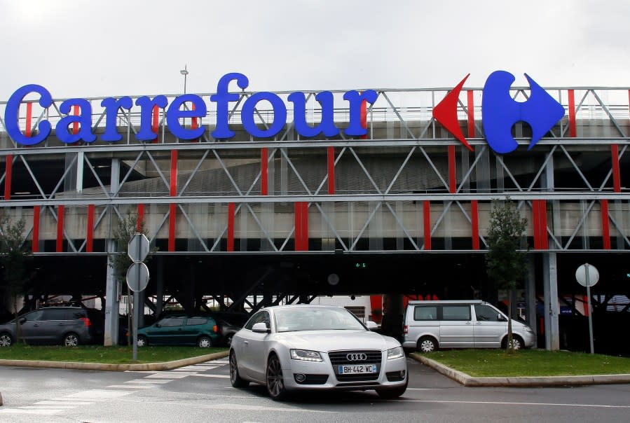 FILE – Car leaves a Carrefour supermarket in Anglet, southwestern France, on Jan.23, 2018. Global supermarket chain Carrefour will stop selling PepsiCo products in its stores in France, Belgium, Spain and Italy over price increases for popular items like Lay’s potato chips, Quaker Oats, Lipton tea and its namesake soda. (AP Photo/Bob Edme, File)