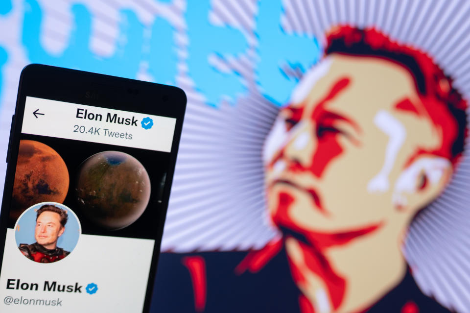 Elon Musk&#39;s Twitter account displayed on a mobile with Elon Musk in the background are seen in this illustration. In Brussels - Belgium on 19 November 2022.  (Photo illustration by Jonathan Raa/NurPhoto via Getty Images)