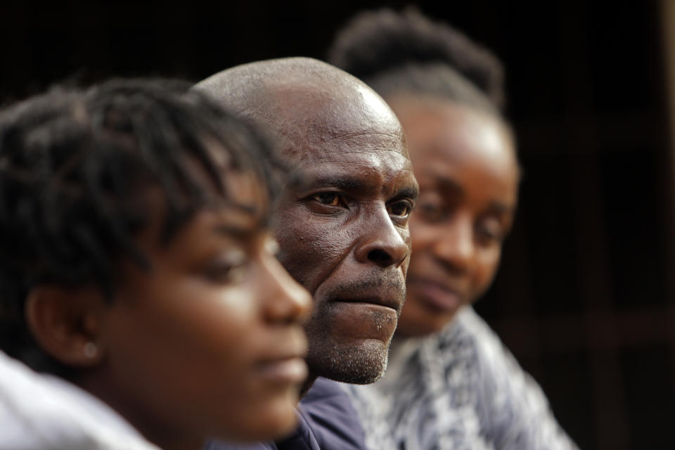 Andrew Ngwenya, center, and his wife, De-egma, right, and daughter sit outside their home in a working class township in Harare, the capital of Zimbabwe, on Monday, July, 12, 2021. Ngwenya and his wife went to a hospital that sometimes had spare doses, only to be turned away due to shortages with only a handful of people being inoculated. (AP Photo/Tsvangirayi Mukwazhi)