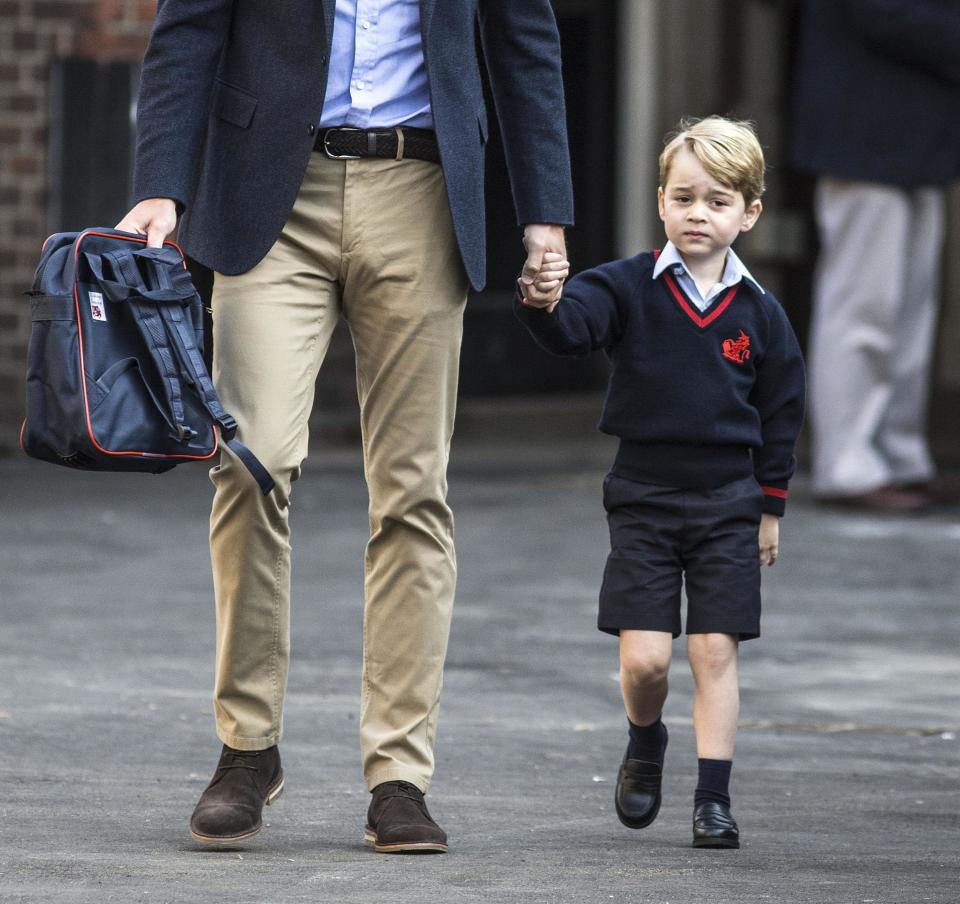 Prince George arriving for his first day at Battersea school, accompanied by his father: PA