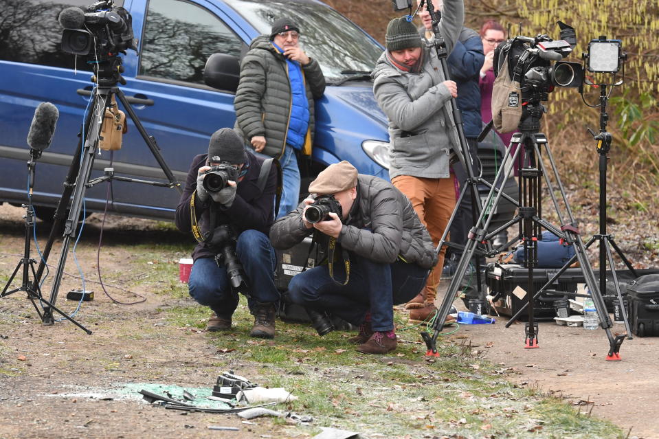 Media film broken glass and car parts on the side of the A149 near to the Sandringham Estate where the Duke of Edinburgh was involved in a road accident yesterday while driving [Photo: PA]