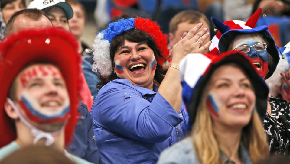 Russian fans support their team during the Group B preliminary round match between Switzerland and Russia at the Ice Hockey World Championship in Minsk, Belarus, Friday, May 9, 2014. (AP Photo/Darko Bandic)