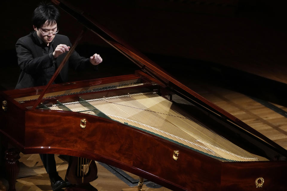 Canadian pianist Eric Guo plays Frederic Chopin's Concerto in F minor on a replica of a 1830 Pleyel piano during a concert marking the 19th century piano virutoso and composer's 214th birthday, in Warsaw, Poland, on Friday, March 1, 2024. Guo won a quintannual competition to play Chopin on period instruments organized by the Fryderyk Chopin Institute. (AP Photo/Czarek Sokolowski)