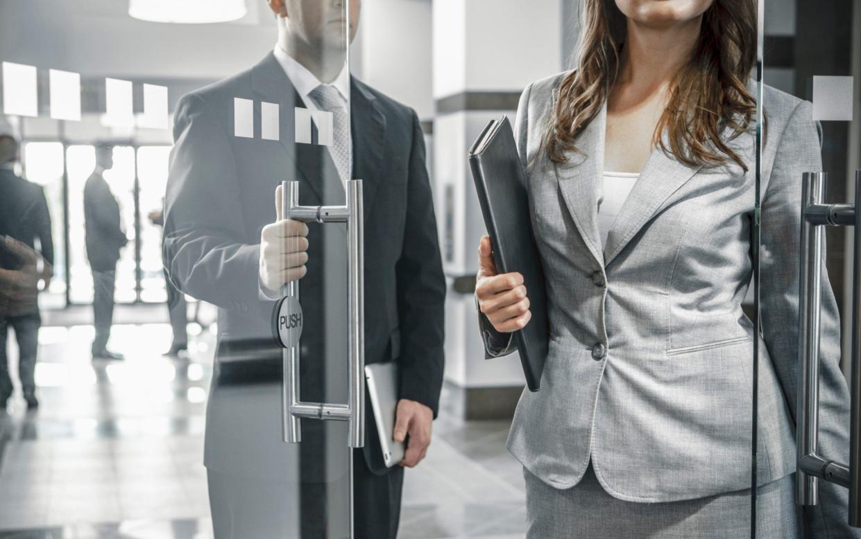 Man opening door for woman