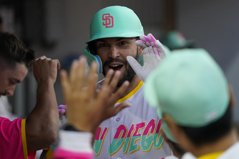 San Diego Padres' Eric Hosmer reacts with teammates after hitting a home run during the fourth inning of a baseball game against the Minnesota Twins, Friday, July 29, 2022, in San Diego. (AP Photo/Gregory Bull)