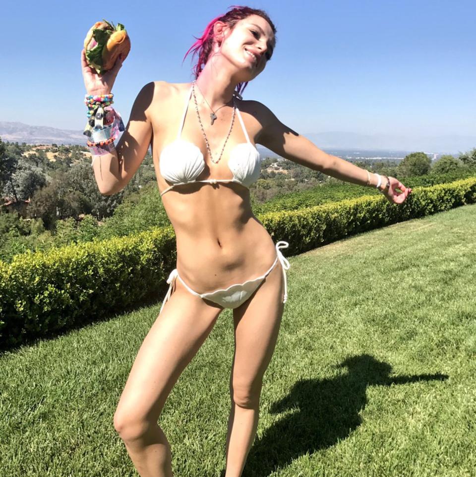 Bella Thorne Dressed in a White Bikini While Eating Her Burger So It Could Really Shine in This Photo