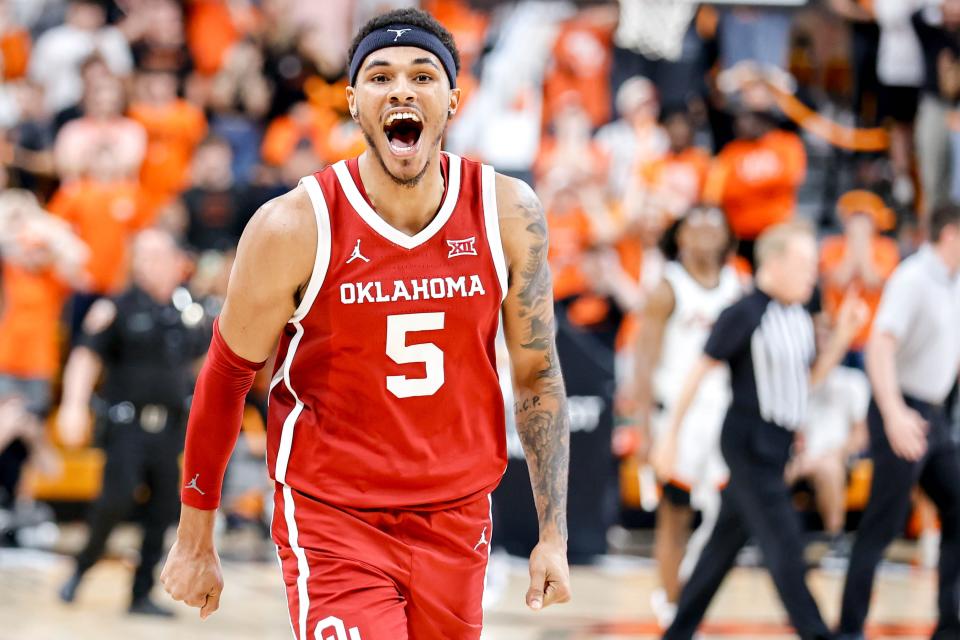 OU guard Rivaldo Soares (5) smiles at the OSU student section after the Sooners' 84-82 overtime win Saturday in Stillwater.