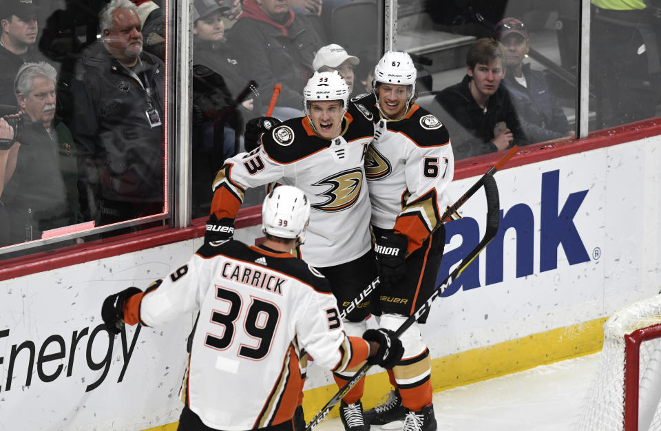Anaheim Ducks' Rickard Rakell, right, of Sweden, celebrates with teammates Jakob Silfverberg, center, of Sweden and Sam Carrick (39) in the first period of an NHL hockey game against the Minnesota Wild, Tuesday, Dec. 10, 2019, in St. Paul, Minn. (AP Photo/Tom Olmscheid)