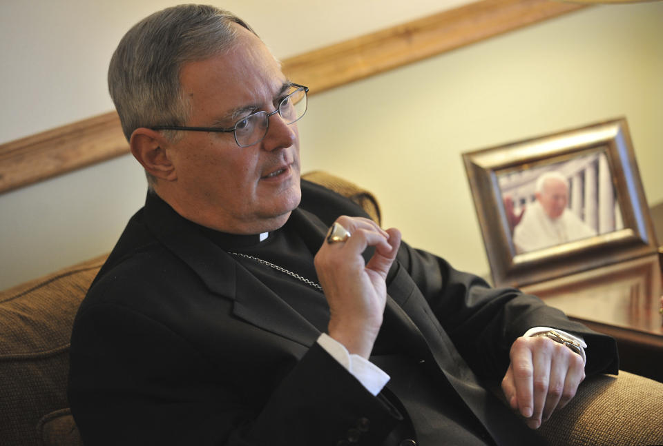 FILE - In this Nov. 22, 2009 file photo, Roman Catholic Bishop Thomas Tobin speaks to a reporter in Riverside, R.I. Tobin is holding a day of prayer and penance because of the clerical sex abuse scandal. Diocese of Providence Bishop Thomas Tobin says these are "difficult and dark days" for the church. The event takes place Friday, Sept. 14, 2018. (AP Photo/Josh Reynolds)