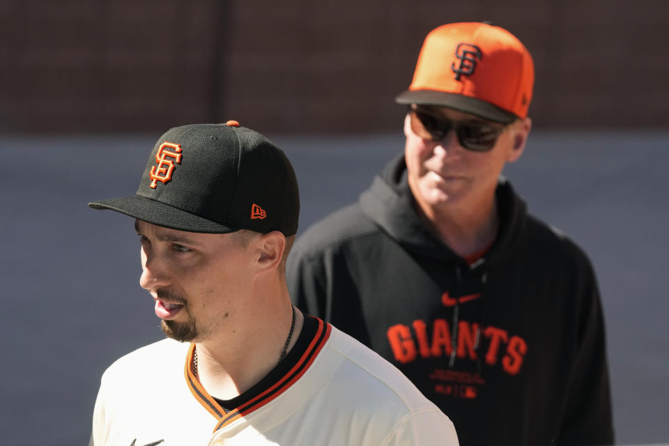 New San Francisco Giants pitcher Blake Snell, left, walks with Giants manager Bob Melvin prior to Snell being introduced at a baseball news conference Wednesday, March 20, 2024, in Scottsdale, Ariz. (AP Photo/Ross D. Franklin)