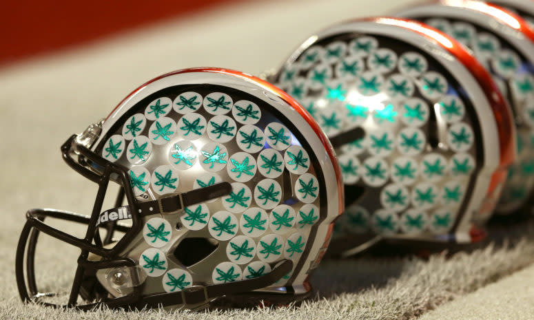 A closeup of an Ohio State football helmet with Buckeyes stickers.