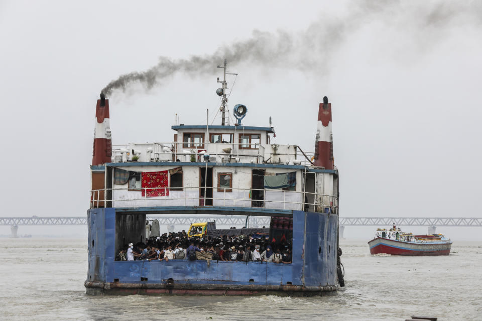 People crowd a ferry to leave the city ahead of a lockdown set to start on July 1, at the Shimulia ferry terminal in Munshiganj, on the outskirts of Dhaka, Bangladesh, Wednesday, June 30, 2021. (AP Photo/Mahmud Hossain Opu)