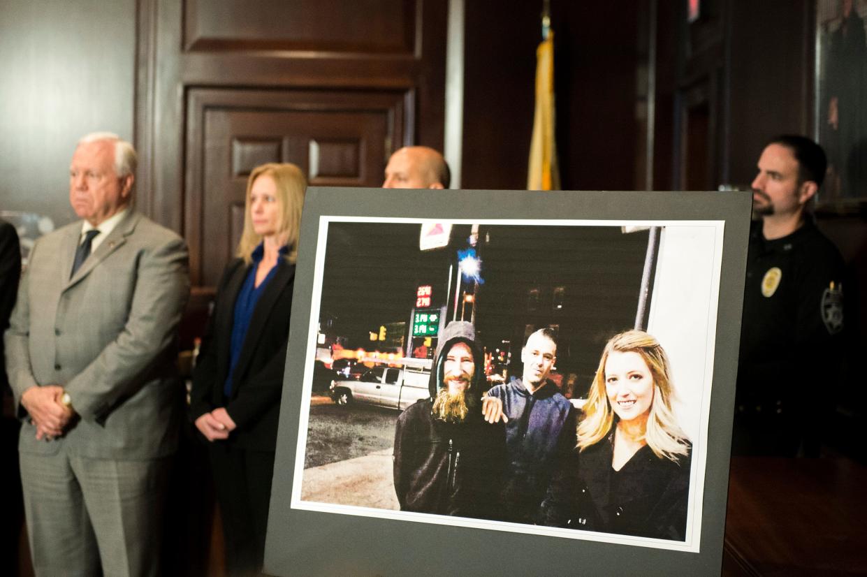 An image of Johnny Bobbitt Jr., from left, Mark D'Amico and Katelyn McClure on display during a press conference Thursday, Nov. 15, 2018 in Mount Holly, N.J. The three are charged in a conspiracy to defraud GoFundMe contributors.