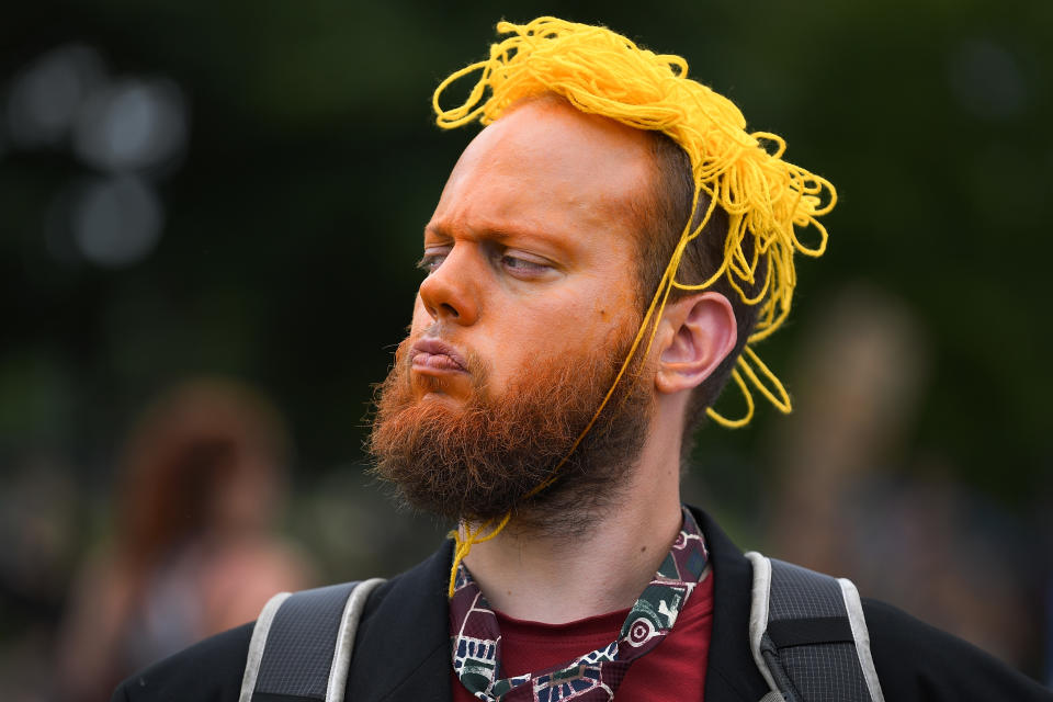 <p>A protester wears orange face makeup and orange string in his hair during an anti-Trump rally on July 14, 2018, in Edinburgh, Scotland. (Photo: Jeff J. Mitchell/Getty Images) </p>