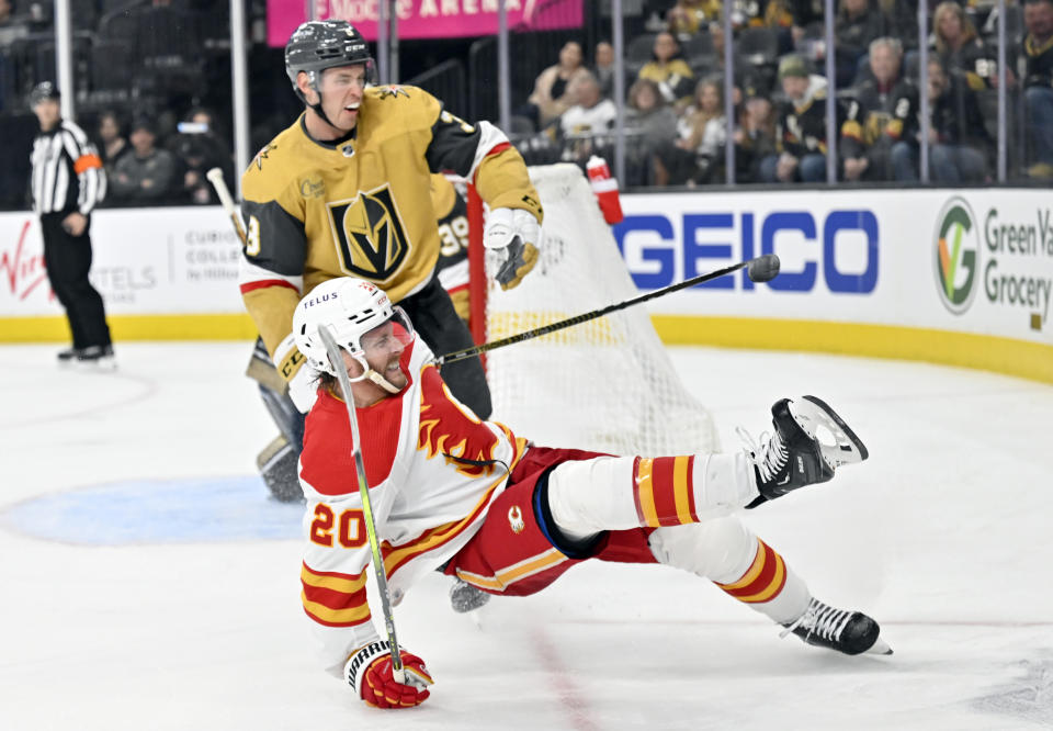 Calgary Flames center Blake Coleman (20) falls to the ice near Vegas Golden Knights defenseman Brayden McNabb during the third period of an NHL hockey game Thursday, Feb. 23, 2023, in Las Vegas. (AP Photo/David Becker)