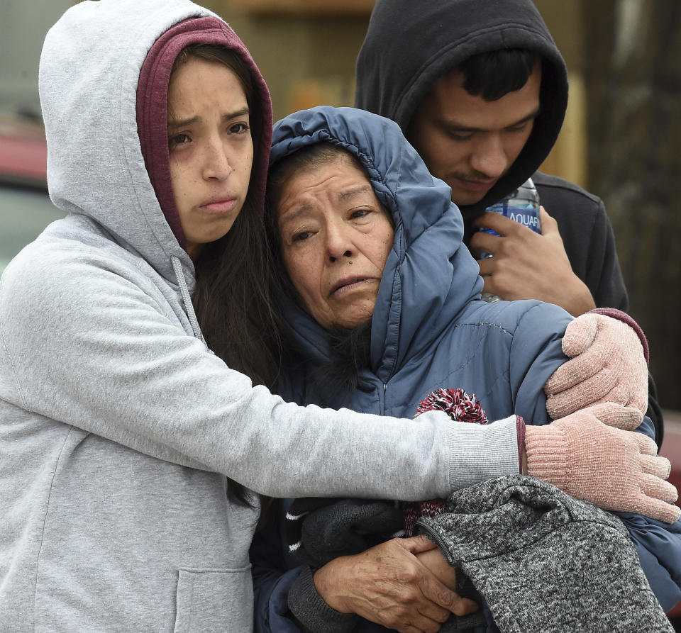 Family members mourn at the scene where their loved ones were killed early Sunday, May 9, 2021, in Colorado Springs, Colo. The suspected shooter was the boyfriend of a female victim at the party attended by friends, family and children. He walked inside and opened fire before shooting himself, police said. Children at the attack weren’t hurt and were placed with relatives. (Jerilee Bennett/The Gazette via AP)