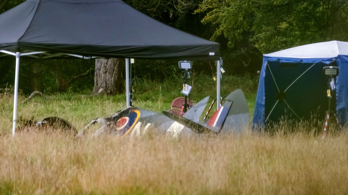 Police and emergency responders at the scene of an aircraft crash in a field near Enstoe ( SWNS)